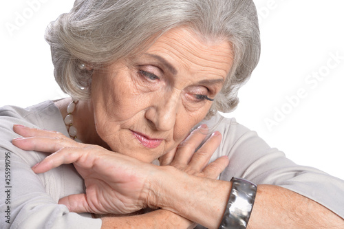 Portrait of sad senior woman on white background