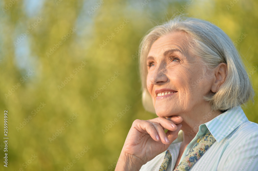 Portrait of beautiful elderly woman posing outdoors Portrait of beautiful elderly woman posing outdoors