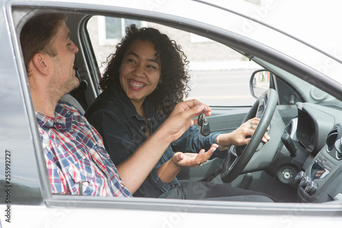 Ethnic couple with a car in the city