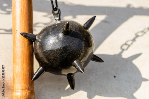 Morning Star, a medieval weapon made of a heavy iron ball with spikes, which is attached to a wooden stick by a chain photo