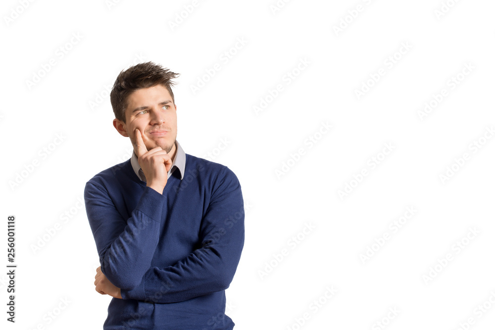 Young thoughtful man in blue sweater and shirt posing on white background Young thoughtful man in blue sweater and shirt posing on white background