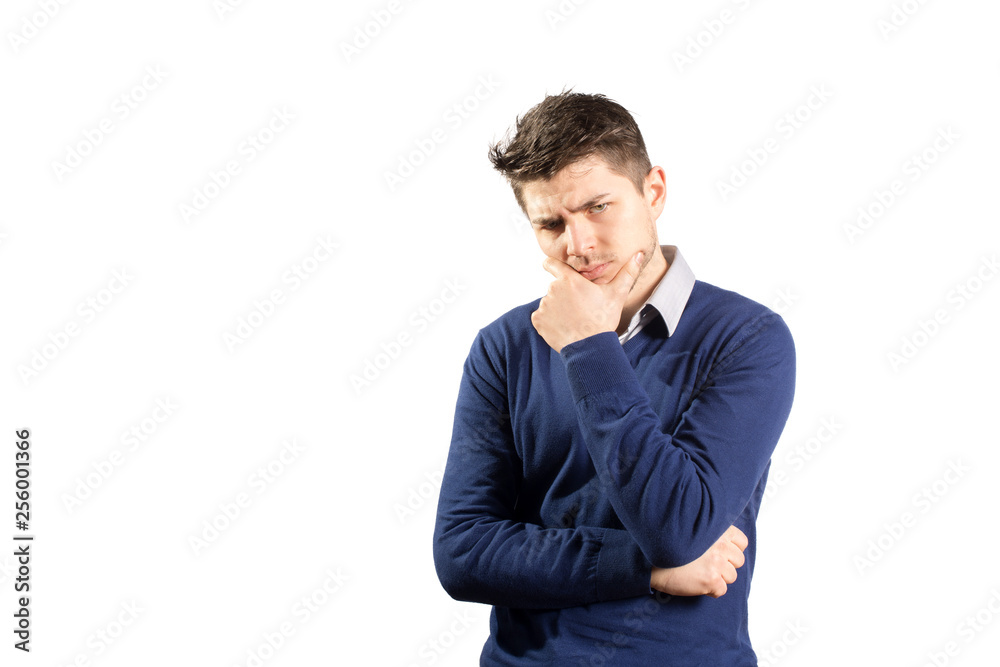 Young thoughtful man in blue sweater and shirt posing on white background Young thoughtful man in blue sweater and shirt posing on white background