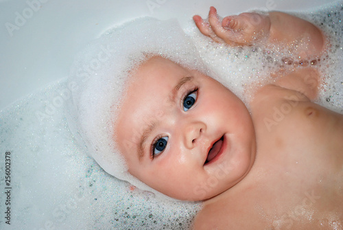 beautiful baby girl bathing in a bubble bath