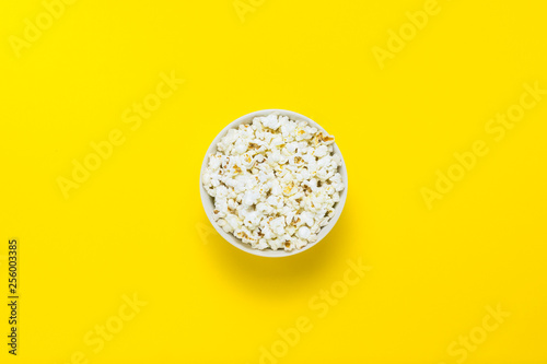Bowl with popcorn on a yellow background. Flat lay  top view.