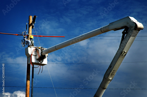 Man Worker Working on Power Lines Crane Bucket High in the Air Dangerous