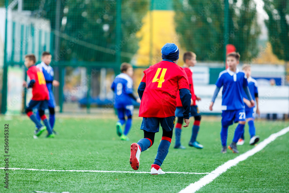 Football training soccer for kids. Boy runs kicks dribbles soccer balls. Young footballers dribble and kick football ball in game. Training, active lifestyle, sport, children activity concept 