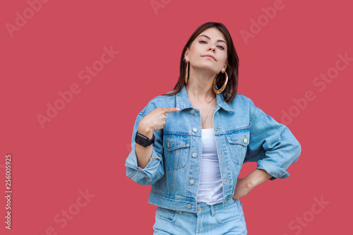 Photography Portrait of proud beautiful brunette young woman with makeup in denim casual style standing, pointing herself and looking at camera with haughty face