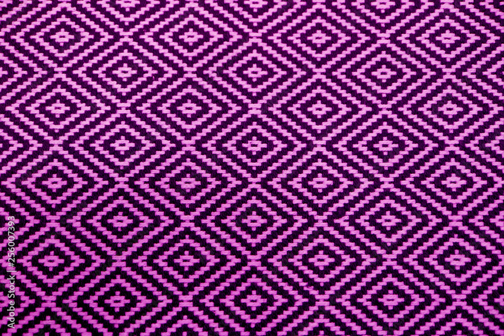 Front view of vibrant purple and black ethnic pattern fabric for background or banner