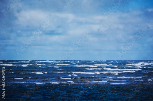 Rolling waves on a deep blue ocean. With added texture.