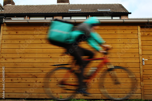 A person on his bike, blurry because of dangerous high speed