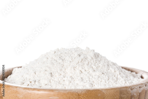 White rice flour in a bowl isolated on white background. Close up. Copyspace