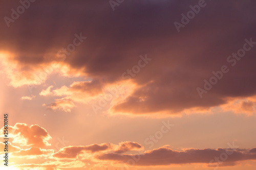 Warm gold sunset sunshines between clouds © Petrova-Apostolova