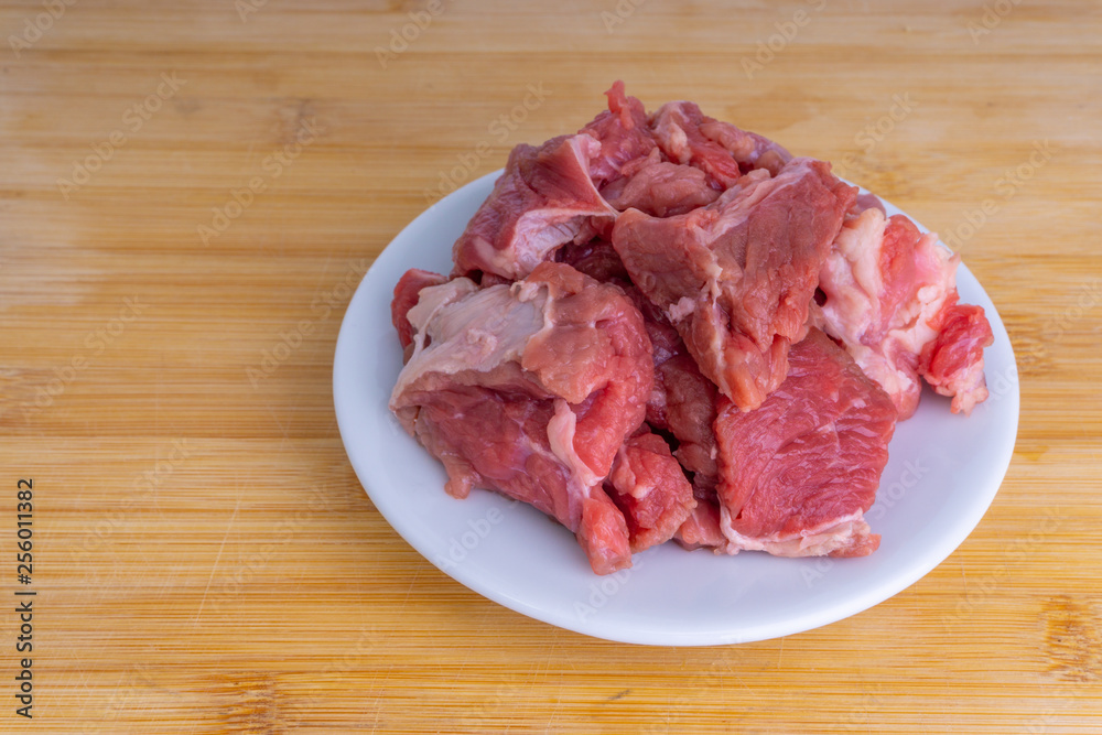 Fresh raw beef steak on wooden background with selective focus Fresh raw beef steak on wooden background with selective focus