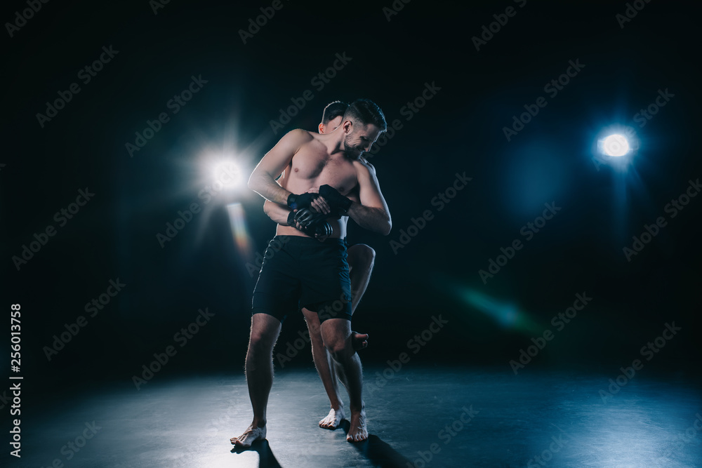 mma fighter doing clinch to another sportsman behind back during training mma fighter doing clinch to another sportsman behind back during training