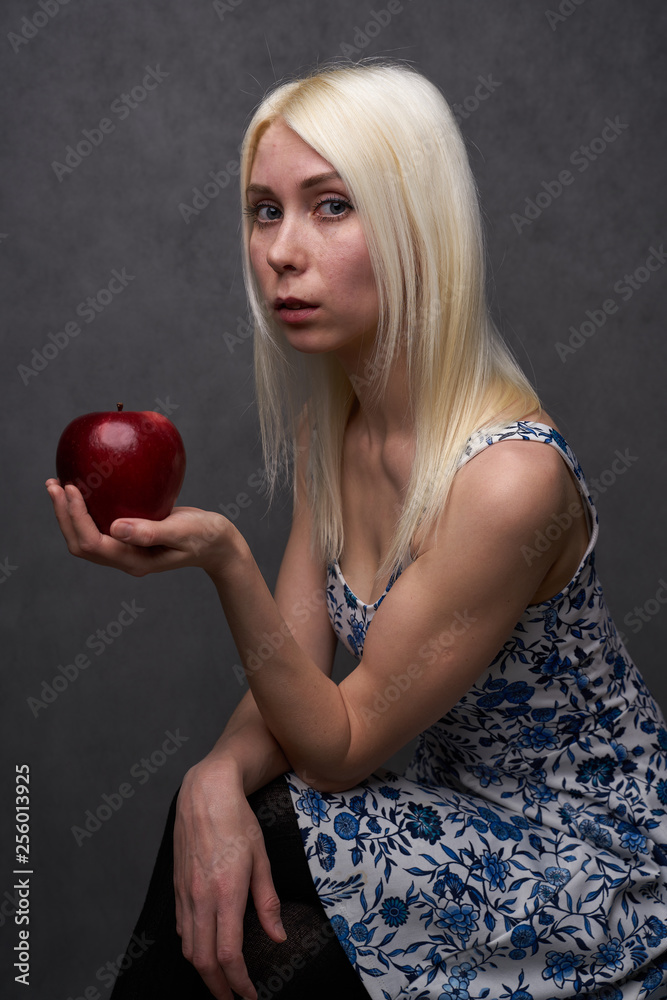 beautiful girl in a fashionable dress with apple beautiful girl in a fashionable dress with apple