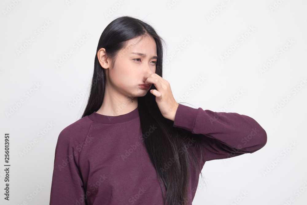Young Asian woman holding her nose because of a bad smell. Young Asian woman holding her nose because of a bad smell.