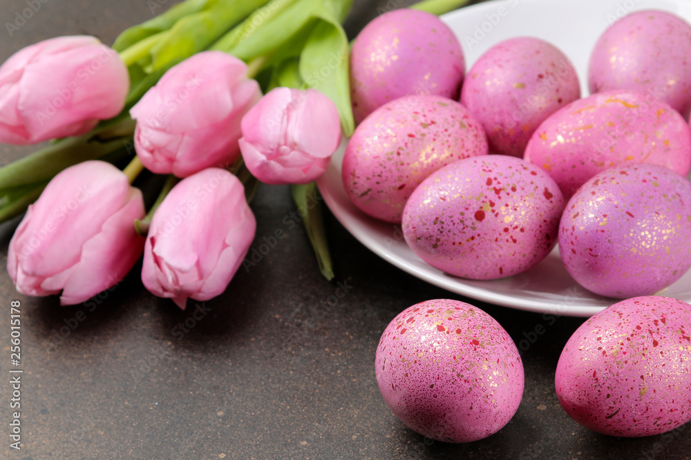 Easter. Pink Easter eggs and flowers tulips on a dark background. Happy easter. holidays. Easter. Pink Easter eggs and flowers tulips on a dark background. Happy easter. holidays.