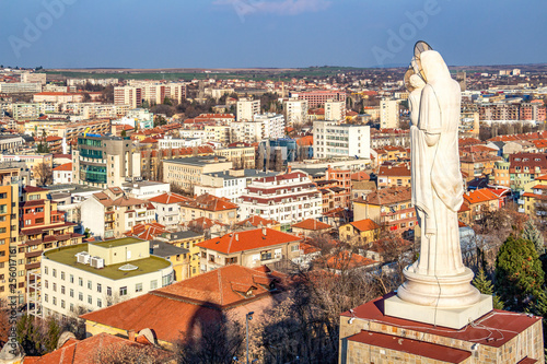 Elevated view to the town of Haskovo, Bulgaria and the Monument of the Holy Mother of God, the highest statue of Virgin Mary in the world photo