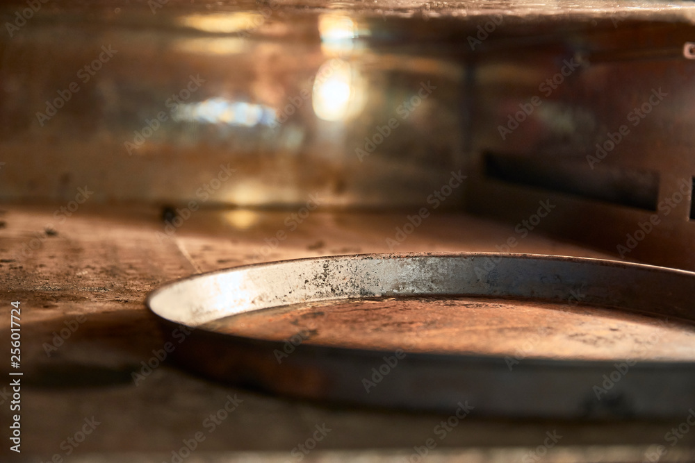 A modern oven for baking pizza in a restaurant. Dirty, rusty, dry cheese, burnt, heat. Metal tray. A modern oven for baking pizza in a restaurant. Dirty, rusty, dry cheese, burnt, heat. Metal tray.