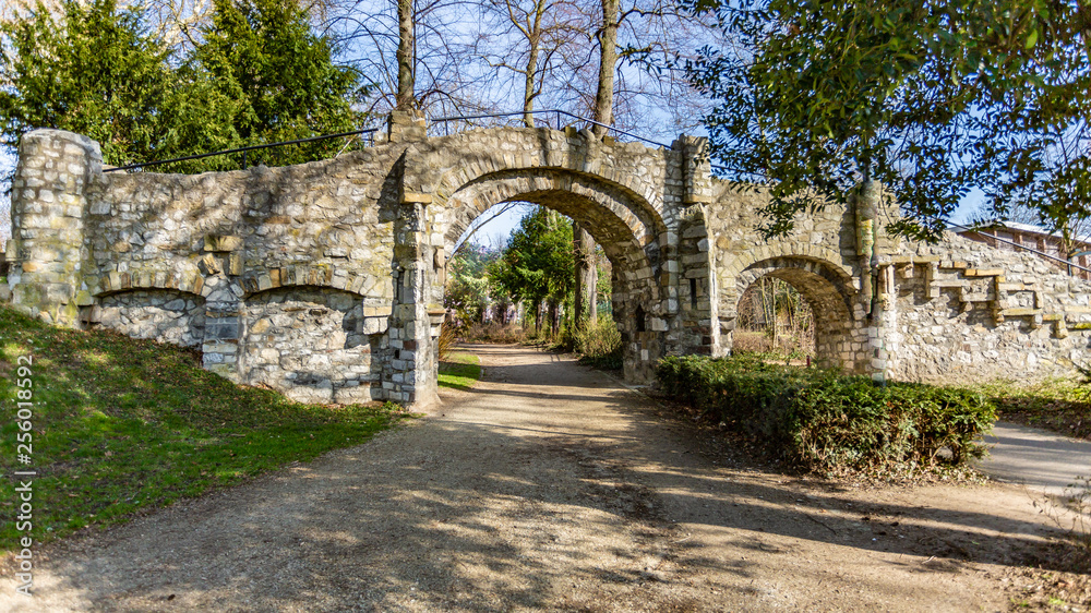 Old stone bridge with two arches, a dirt road in the Proosdij park, wonderful and sunny day in Meerssen south Limburg in the Netherlands Holland