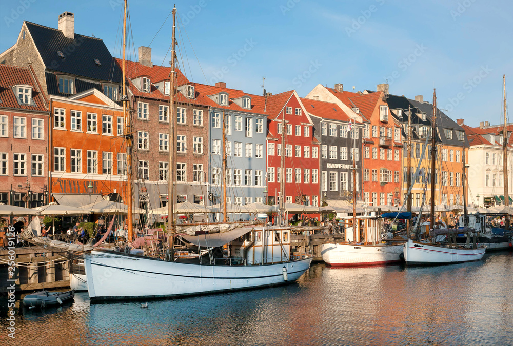 Riverboats, yachts and historical area of Nyhavn with outdoor restaurants of danish capital