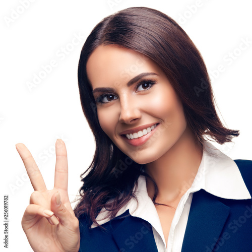 Businesswoman showing two fingers or victory gesture