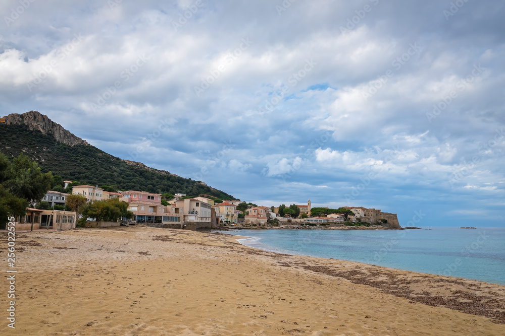 View of the Corsican village Algajola from the sandy beach, France
