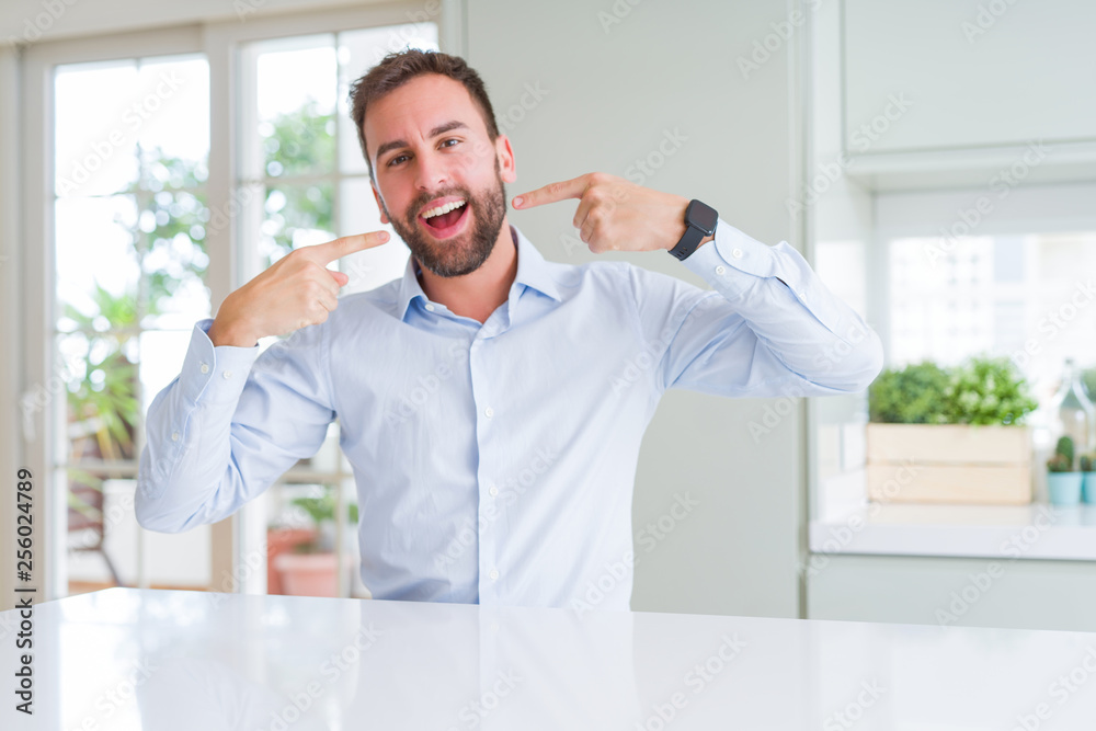 Handsome business man smiling confident showing and pointing with fingers teeth and mouth. Health concept.