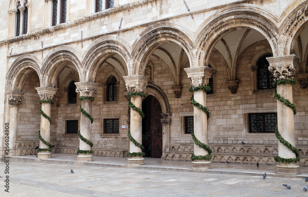 Columns and exterior of the Duke's Palace (Knezev dvor) decorated with Advent wreaths in Dubrovnik, Croatia 