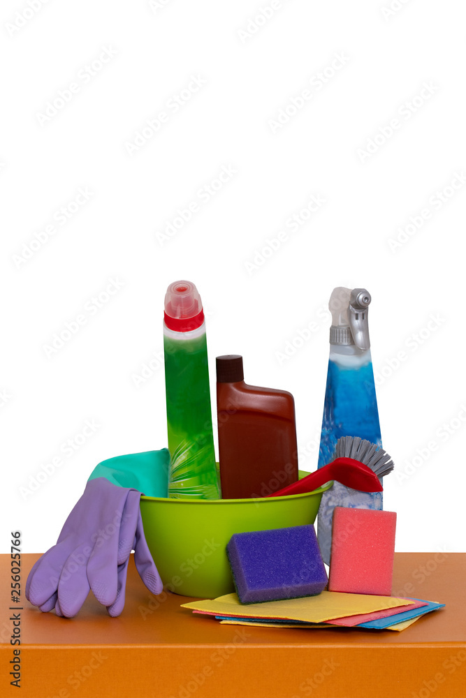Spring cleaning background. Close-up of house cleaning products and cleaning supplies on orange wooden table isolated on a white background. Household chore concept. Macro. Spring cleaning background. Close-up of house cleaning products and cleaning supplies on orange wooden table isolated on a white background. Household chore concept. Macro.