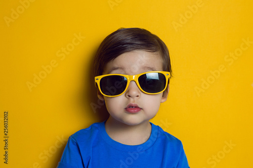 cheerful baby boy in blue t-shirt stands © saulich84