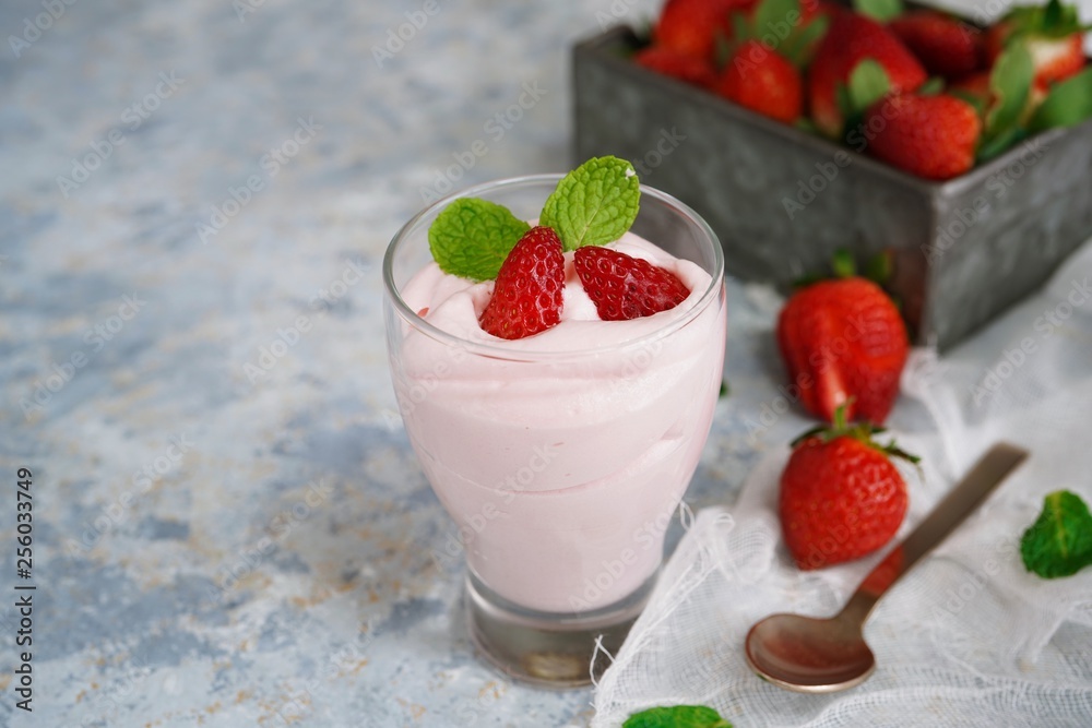 Homemade Strawberry Mousse topped with berries and mint leaf garnish, selective focus Homemade Strawberry Mousse topped with berries and mint leaf garnish, selective focus
