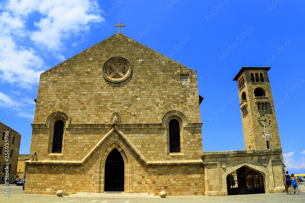 Medieval old  Orthodox Church of the Annunciation,   Church building with clock tower , Rhodes, Greece - a beautiful place for excursions, travel, recreation and vacation.