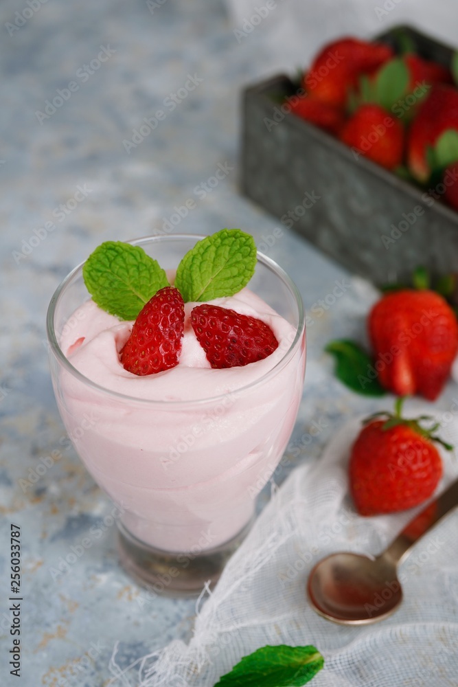 Homemade Strawberry Mousse topped with berries and mint leaf garnish, selective focus Homemade Strawberry Mousse topped with berries and mint leaf garnish, selective focus