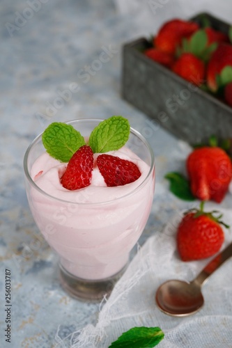 Homemade Strawberry Mousse topped with berries and mint leaf garnish  selective focus