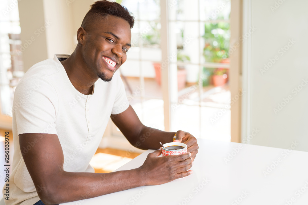 African american man smiling confident drinking a coffee at home African american man smiling confident drinking a coffee at home