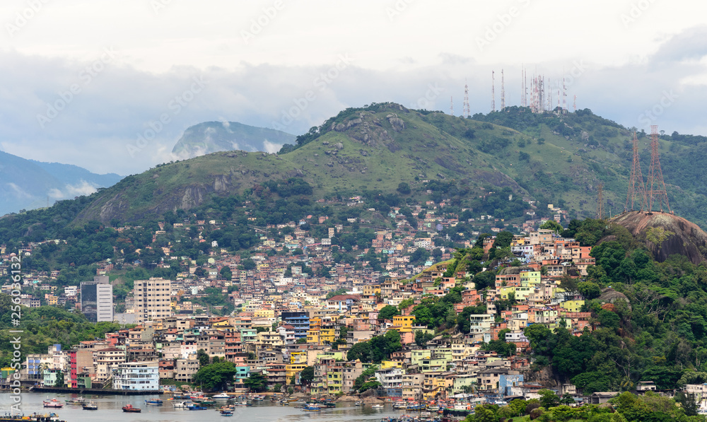 Naklejka premium Aerial view of the beautiful city of Vitoria, Espirito Santo, Brazil and its wide bay. The city developed with its high buildings growing on the hills and into the local greenery