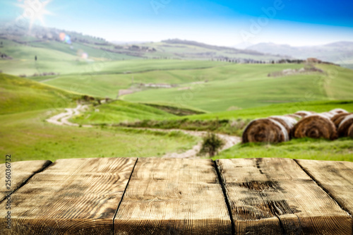 Spring background of table and Tuscany landscape 