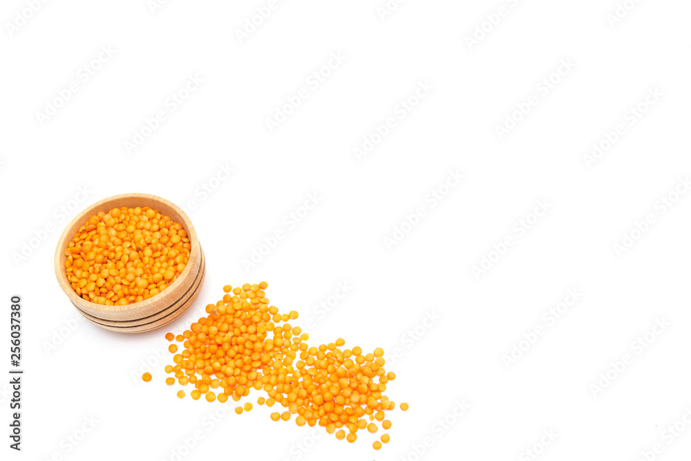 Red lentils in a wooden plate isolated on white background Red lentils in a wooden plate isolated on white background