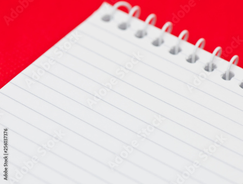Blank sheet of a notebook, on red background