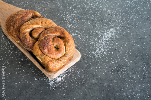 Фотография traditional Dutch cinnamon, sugar bread in a roll, called Zeeuwse Bolus