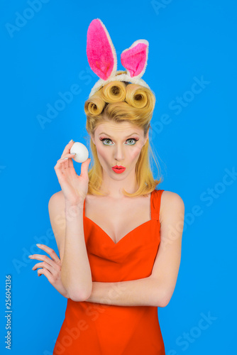 Happy Easter! Spring holiday. Woman with rabbit ears holds white eggs. Egg hunt. Easter bunny. Easter concept. Woman witn bunny ears. White eggs. Bunny girl. Kiss.