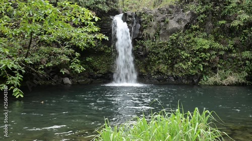 Tropical Waterfall - Close up view of Lower Puaa Kaa Waterfall and a small crystal clear pond, inside of a dense tropical rain-forest, off the Road to Hana Highway, Maui, Hawaii, USA. photo