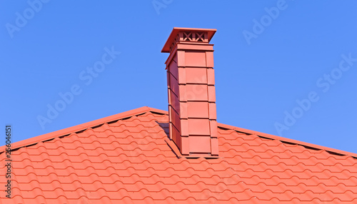 chimney on the roof of the house against sky