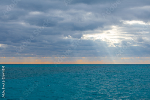 Calm sea w.ater against cloudy and sunny sky. Caribbean Sea in Tulum, Mexico 