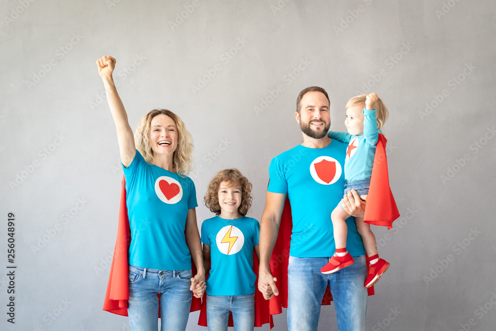 Fototapeta premium Family of superheroes playing at home