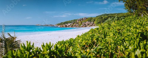 Most beautiful beach Grand Anse on La Digue Island, Seychelles with granite rock formations, white sand and Wild surrounding atmosphere photo