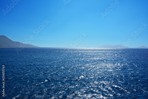 the coastline of the island against the background of the blue sky and the sea in the bright sunny day