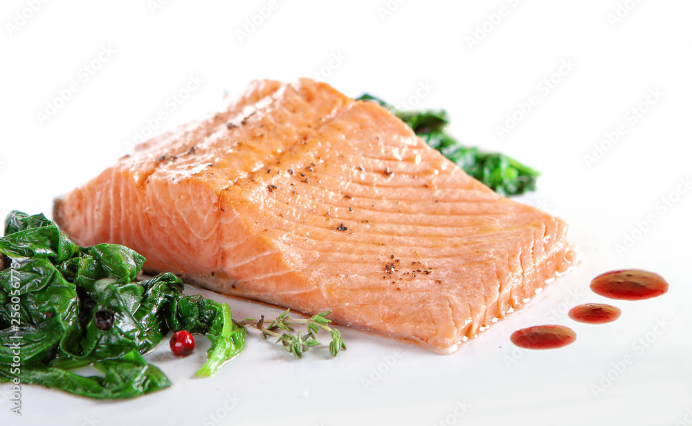A piece of steamed salmon steak with spinach A piece of steamed salmon steak with spinach