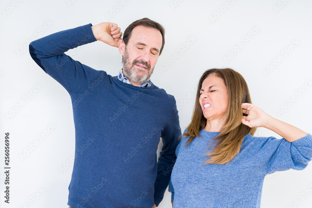 Beautiful middle age couple in love over isolated background stretching back, tired and relaxed, sleepy and yawning for early morning Beautiful middle age couple in love over isolated background stretching back, tired and relaxed, sleepy and yawning for early morning